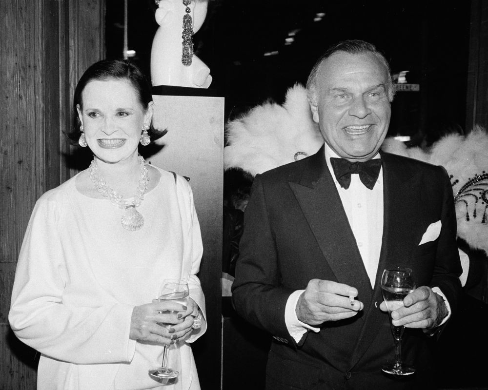 En esta foto de 1982, Gloria Vanderbilt y Bill Blass, ambos diseñadores, se ven saliendo de la celebración del cumpleaños 90 del artista Erte en Nueva York. (AP)